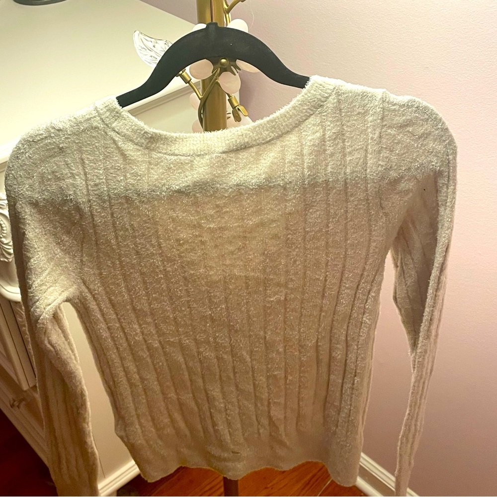 This is a soft cream color top. It is a size 15/16 kids from Abercrombie kids
